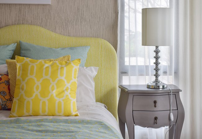 pattern-pillows-on-classic-style-bed-and-reading-lamp